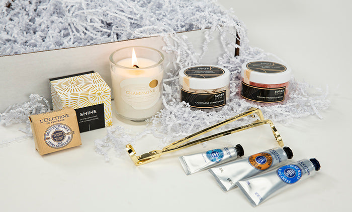 Gift box with candle, creams, tweezers