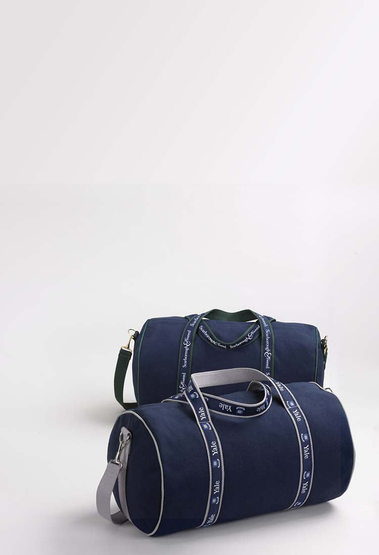Two navy blue duffle banker bags with straps.