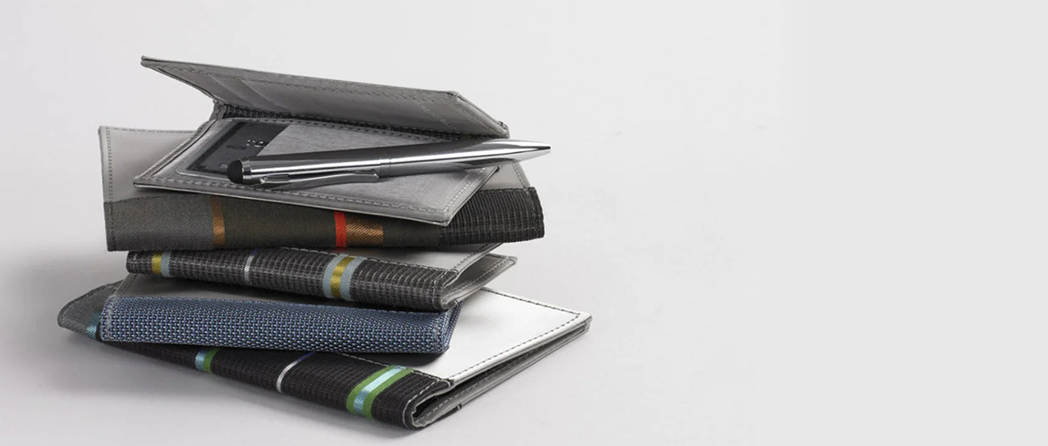 Stack of wallets with a pen on top