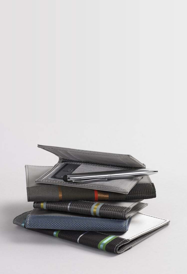 Stack of wallets with a pen on top
