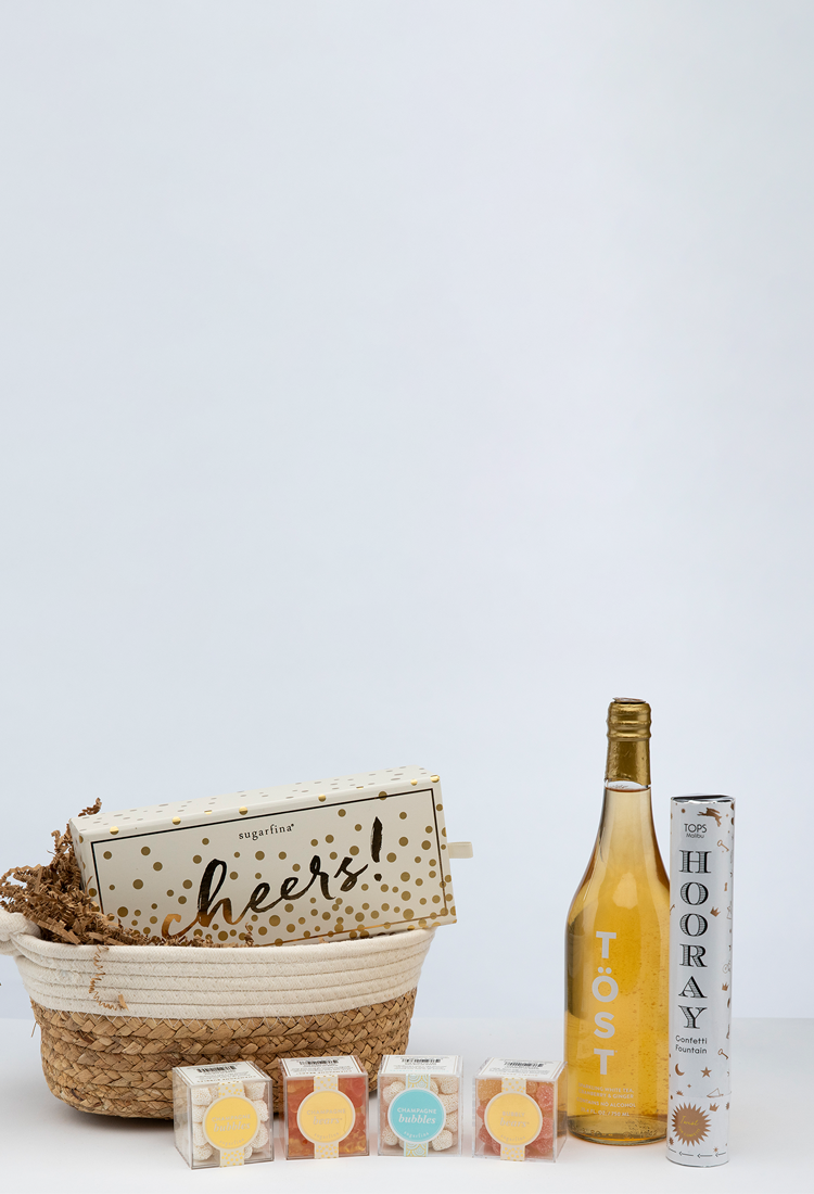 Gift set with sparkling wine, snacks, and celebration items