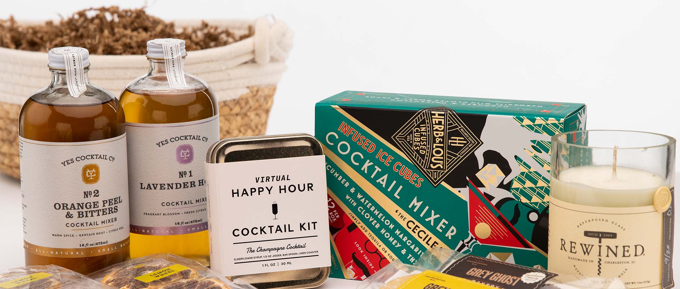 Assorted cocktail mixers, kit, snacks, and candle