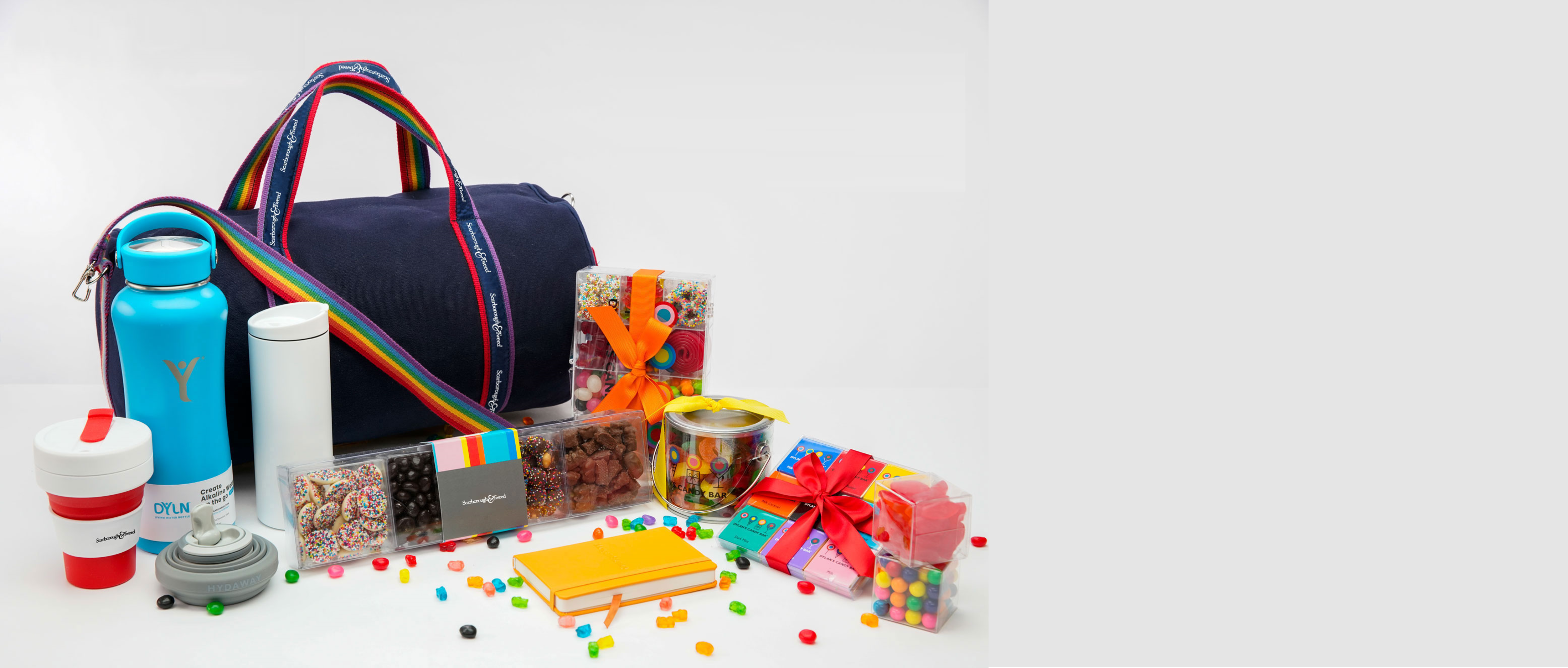 Colorful duffle banker bag with water bottles, snacks, and gifts.