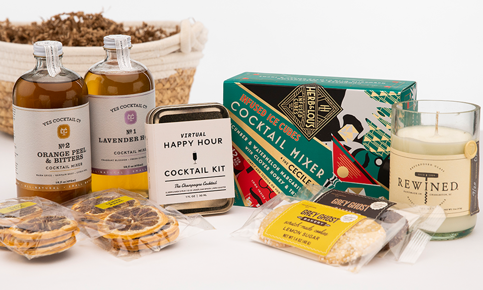 Cocktail gift set with mixers, snacks, and candle.