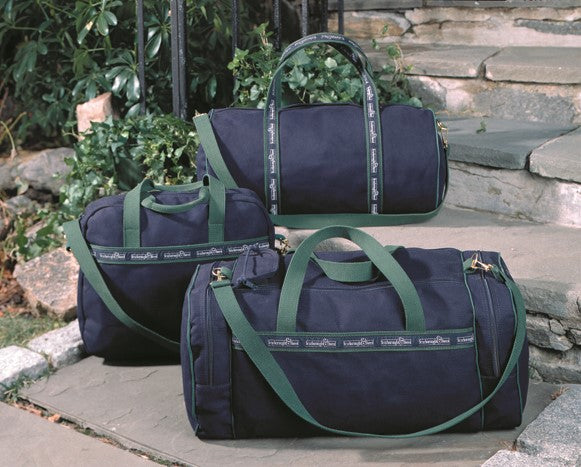 Three navy duffle banker bags with green straps
