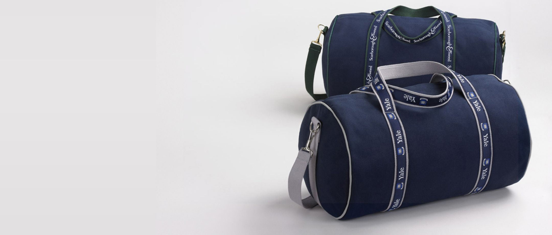 Two navy duffle banker bags with Yale branding.
