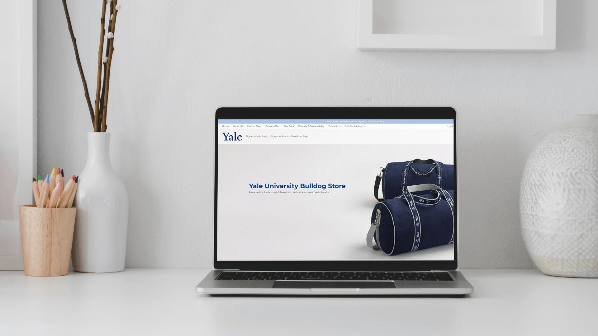 Laptop displaying Yale University Bulldog Store with banker bag.