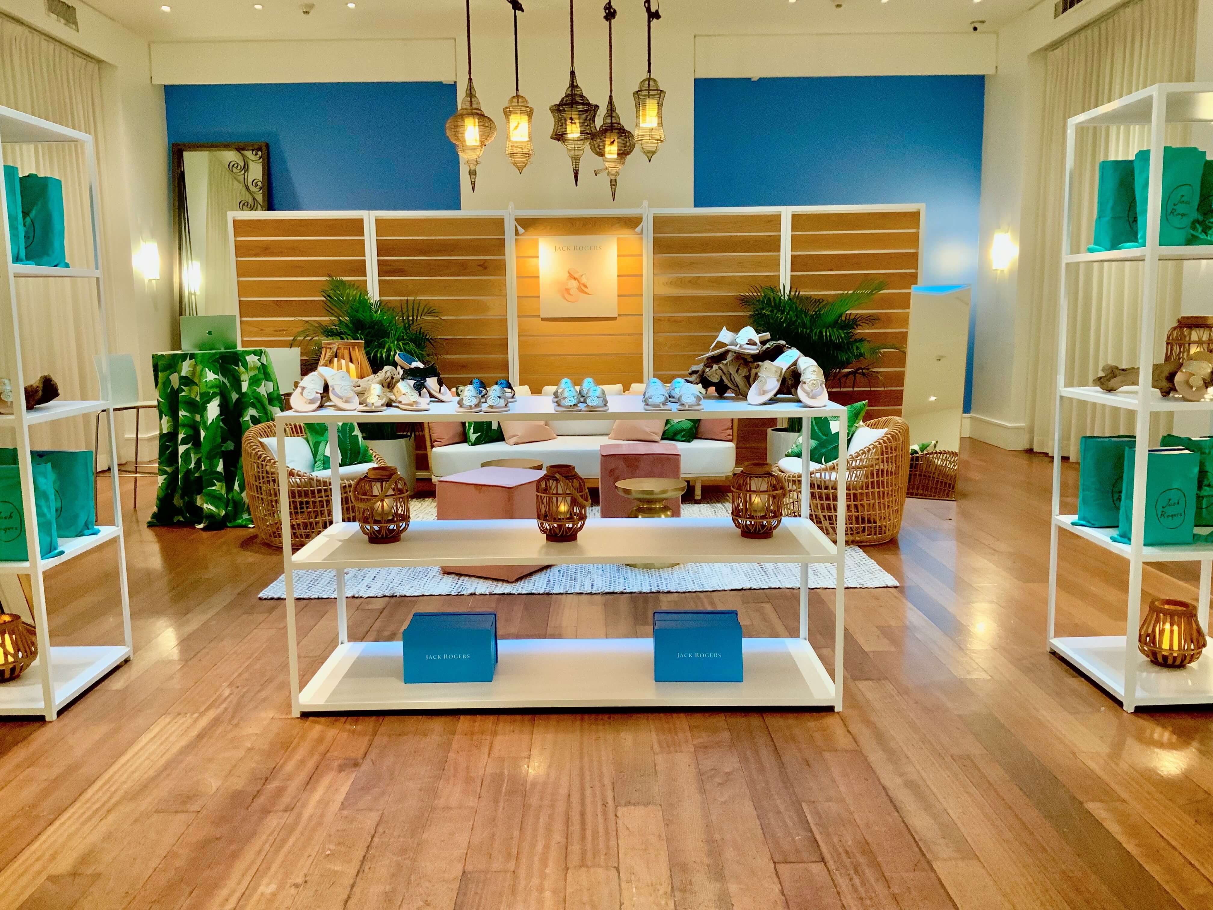 Stylish showroom display with shoes, bags, and decor.